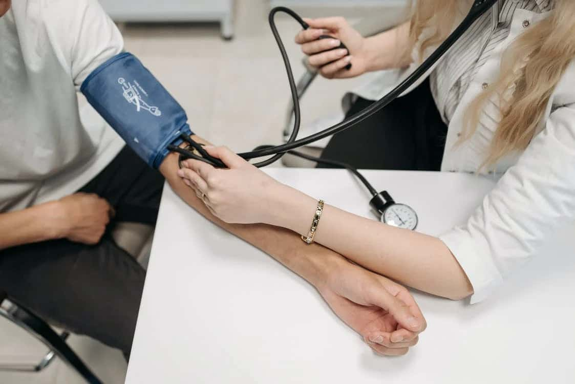 Man sat in chair having his blood pressure